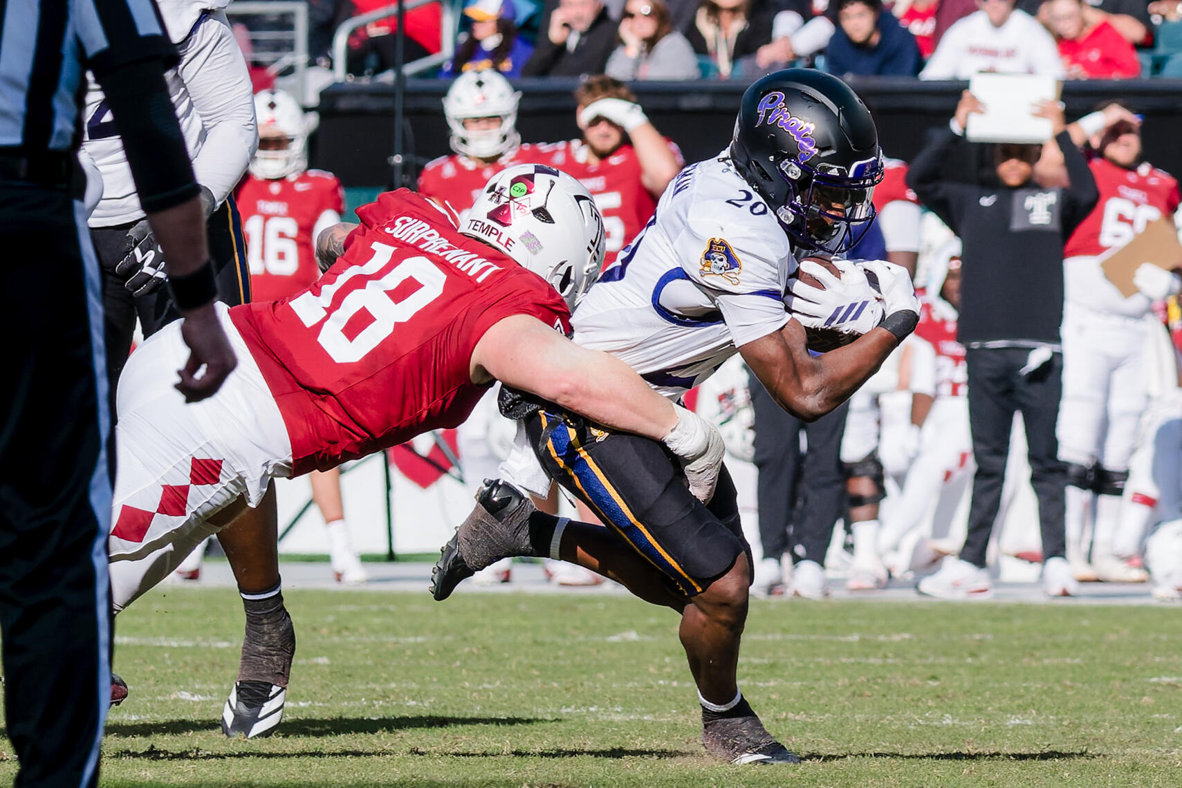 PHILADELPHIA, PA - Temple defensive back Tyler Surprenant (18) tackles East Carolina running back TJ Engleman (20) during a 2025 NCAA football game at Lincoln Financial Field.